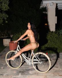 Kim Kardashian Wears Gold Bikini for Late Nite Bike Ride in Italy