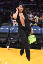 Megan Thee Stallion’s Courtside Style Includes Plunging Top and a Neon Birkin