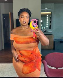 Lizzo Flaunts Her Figure in Orange Form-Fitting Dress for Thanksgiving