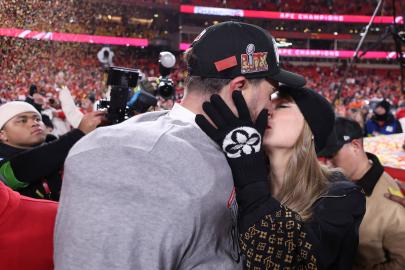 Taylor Swift Kisses and Cuddles Travis Kelce on Field After Chiefs Win